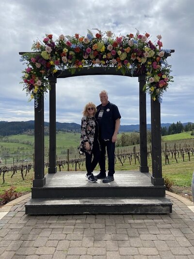 Floral arch at a winery outside Eugene with florist DelJean and her husband Dave of Flowers and Thyme.