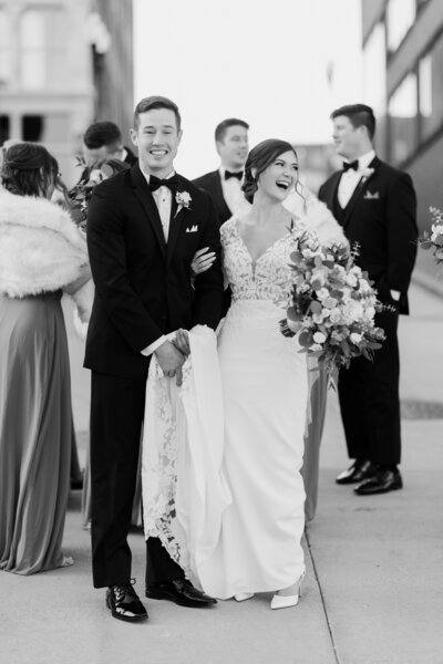Black and white candid image of bride and groom