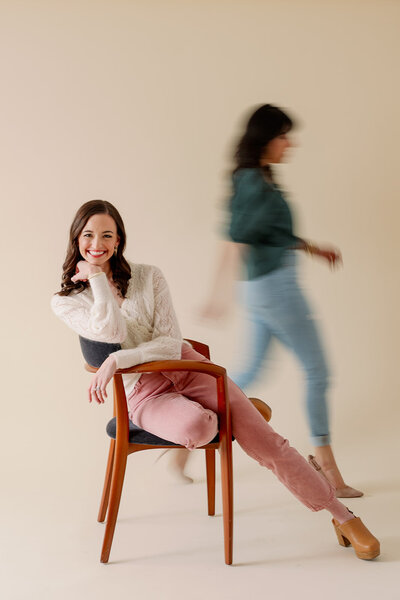 Woman sitting sideways in a chair