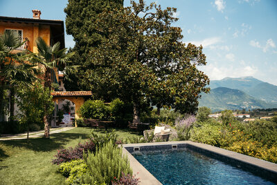 A captivating view from the villa on Lake Garda, with majestic mountains framing the serene waters, creating a picturesque and tranquil scene