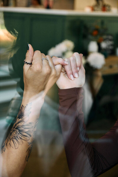 two hands pinkies locked in a pinky promise