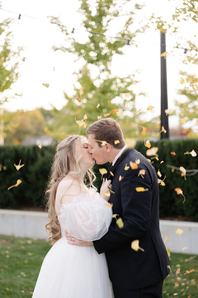 bride and groom kissing under veil photographed by Kaitlin Mendoza Photography, a wedding photographer in Indianapolis