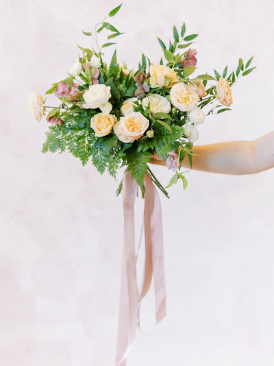 A wedding bouquet with overflowing pink roses at a luxury wedding in northern california
