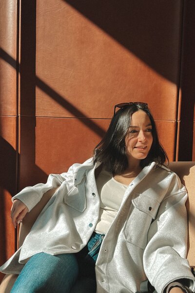 Vickie Chountalos relaxing at the Royal Hotel in Picton, with sunlight casting a warm silhouette against the wall