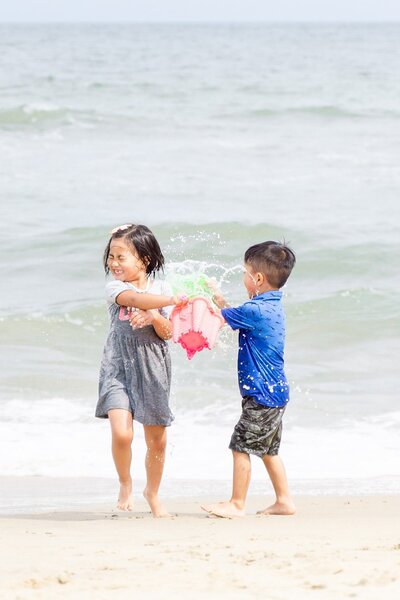 Siblings playing in the beach