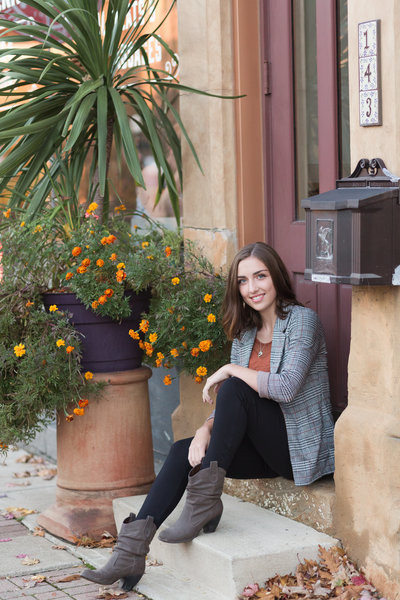 high school senior girl sitting on steps downtown wooster ohio photographed by jamie lynette photography canton ohio senior photographer