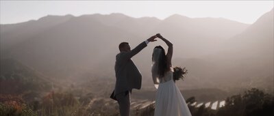 couple spinning on mountaintop