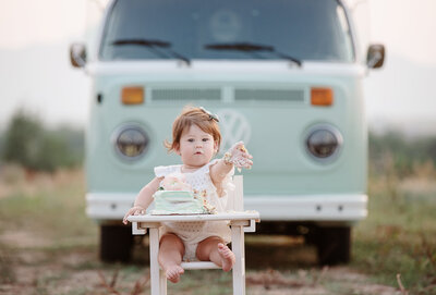 baby girl eating her cake in front of the shutterbus in broomfield, colorado