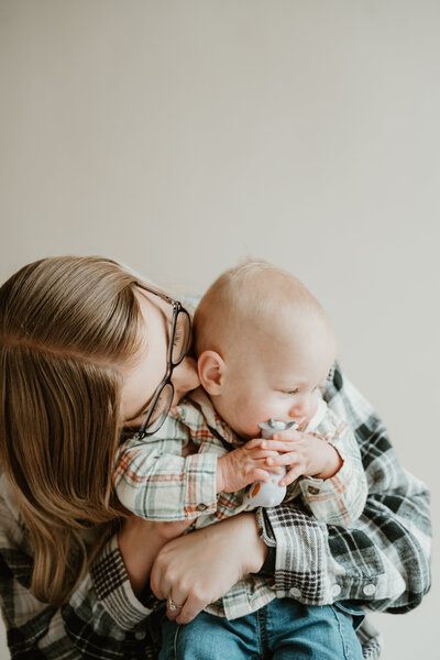 Mom with son with neutral background in flannels