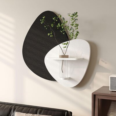 Modern abstract wall art in black and white with built-in vase and greenery, styled above a luxe office setup.