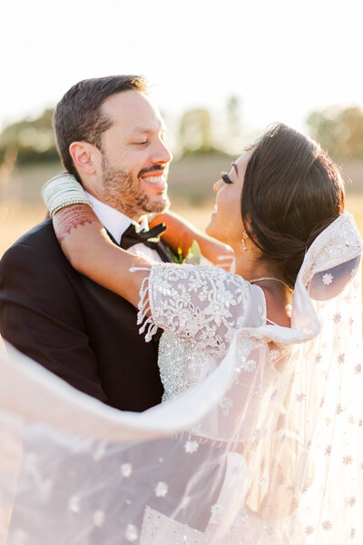 a bride hugging her new husbrand