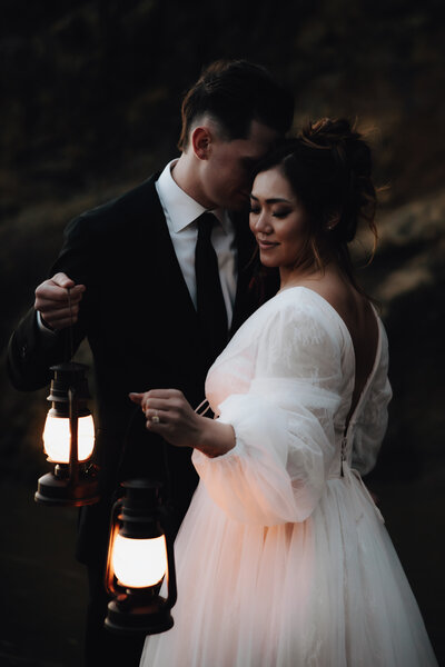 Couple holding lanterns during their Vancouver elopement