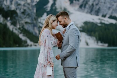 couple sharing vows at lago di braies in the dolomites Italy