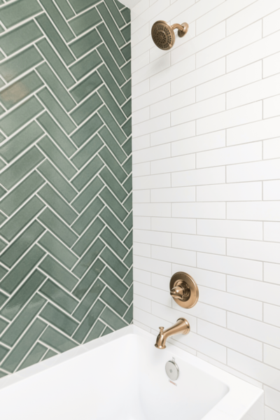 Eco-friendly move-out bathroom cleaning in Edmonton featuring a spotless green and white tiled shower and tub
