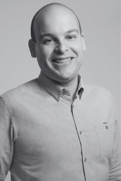 Darren Berkovitz smiling in professional headshot wearing light button-up shirt