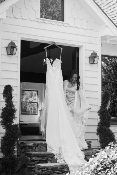 Bride holding her gown in NC backyard wedding