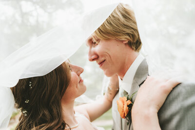 bride holding her dress and bouquet
