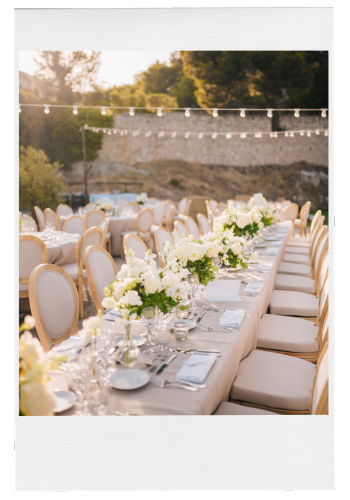 Wedding Venue outdoor reception with cream chairs and white florals