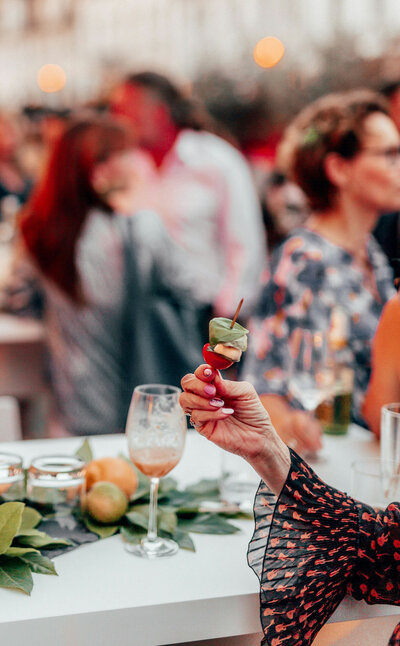 Photo of a woman holding a food in an event