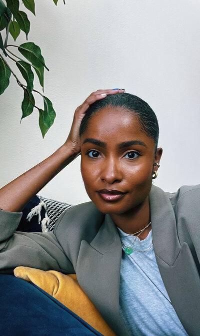 Founder of Sunstone Ops Collective, Dey, seated in calm workspace.