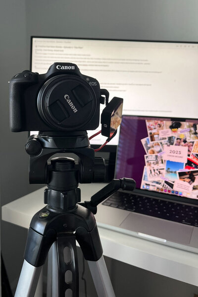 The Creative Cool Mom Setup with a canon camera, rode mic, a laptop and monitor in the background.