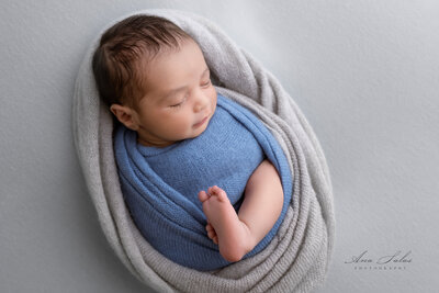 Edmonton Newborn Photography baby in blue grey background