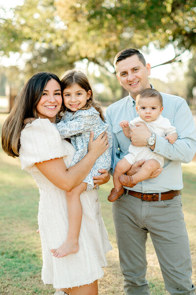 Melony Berg, a realtor at Capital Realty and her family posing for a photo.