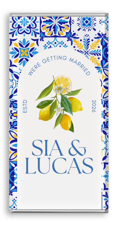 Luxury personalised wedding chocolate bar with blue and white Mediterranean tile pattern, lemon blossom illustration, and names ‘Sia & Lucas’ with the text ‘We’re Getting Married’. Custom chocolate wedding favours by Barilliant, Australia’s No.1 luxury custom chocolate bar brand.
