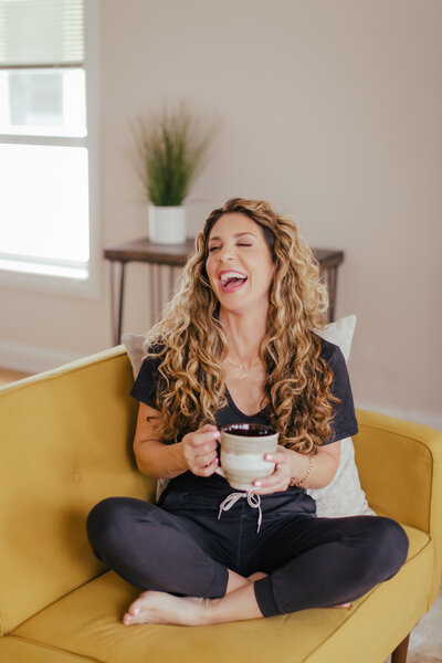 Virginia kerr smiling drinking coffee with mug in her hands