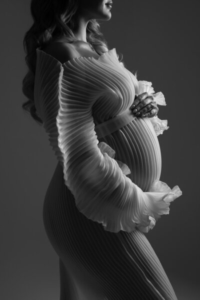Artistic maternity photography in Austin Texas featuring expectant mother with modern fabric draping