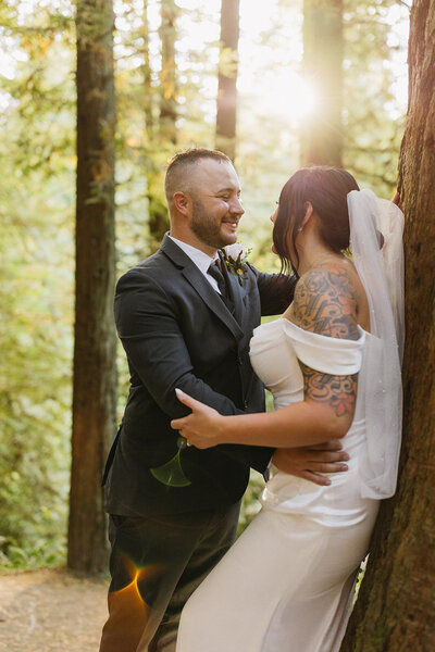 couple hugging during sunset wedding photos in glacier national park
