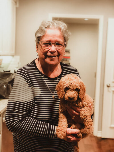 Adorable grandma photo holding a poodle Puppy