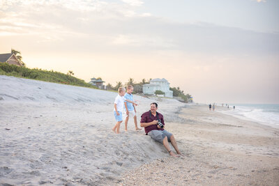 man holding a canon camera on the beach in front of the Disney Vero Beach Resort