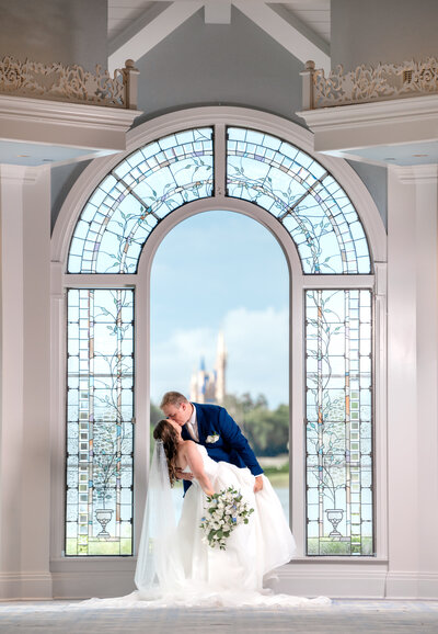 disney castle at the window and couple kissing at wedding