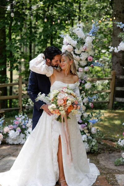 groom hugging bride from behind atlanta wedding