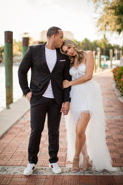 couple kissing at the end of the aisle