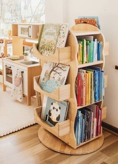 A small wooden book shelf with organized children's books