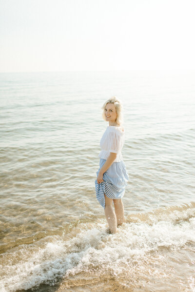 WI Photographer standing in Lake Michigan