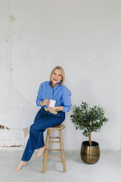 Natasha Sewell sitting on a stool 