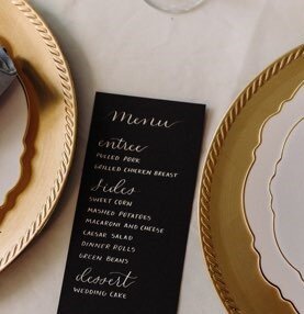 black wedding menu with white ink calligraphy