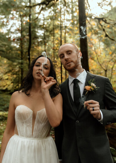 Bride and Groom sharing a joint after a relaxing wedding ceremony on Mount Hood. 420 friendly wedding photographer.