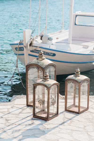 Traditional boat decorated with lanterns floating in the Ionian Sea for a wedding celebration.