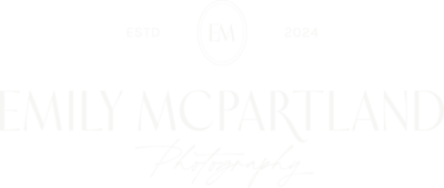 The white version of Emily's logo features "Emily McPartland" stacked above "Photography" in cursive, with a small logomark above and "ESTD 202" underneath.