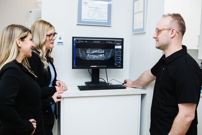 Sleep apnea dentist discusses personalized sleep apnea treatments with a patient, offering expert guidance on custom oral appliances as a comfortable alternative to CPAP therapy.