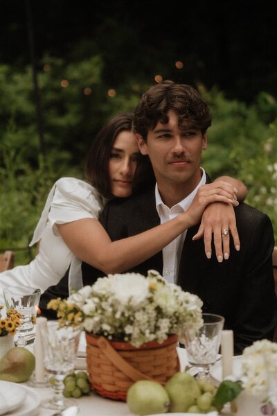 bride and groom in field of flowers and trees