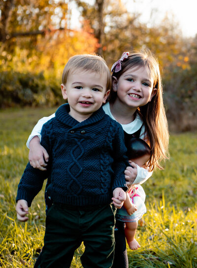 two kids smiling during family photography session