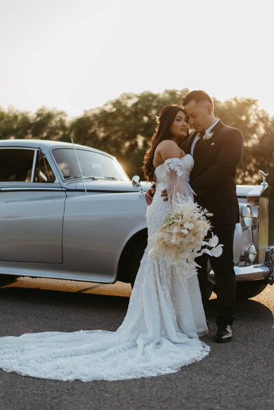 newlyweds in front of vintage car