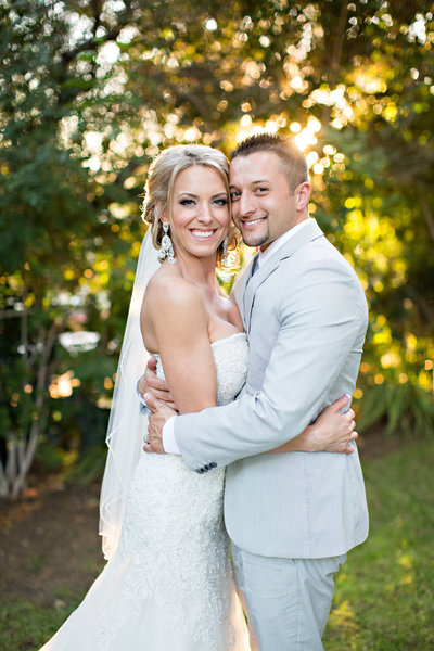 Bride and Groom standing in sunshine at Twin Oaks Garden Estate