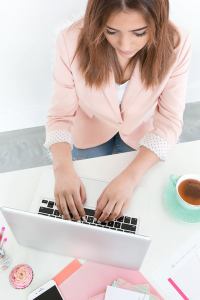 woman typing on a laptop