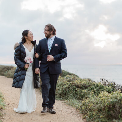 Newly weds walk along a Big Sur trail
